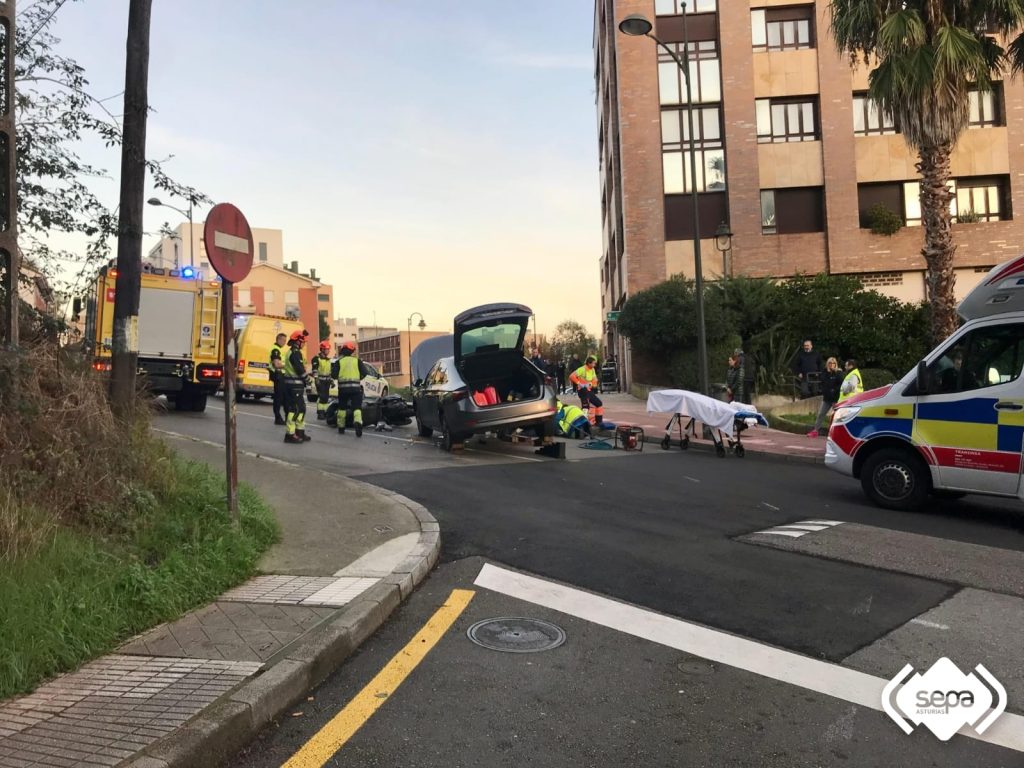 Un motorista ha resultado herido de consideración tras quedar atrapado bajo un coche